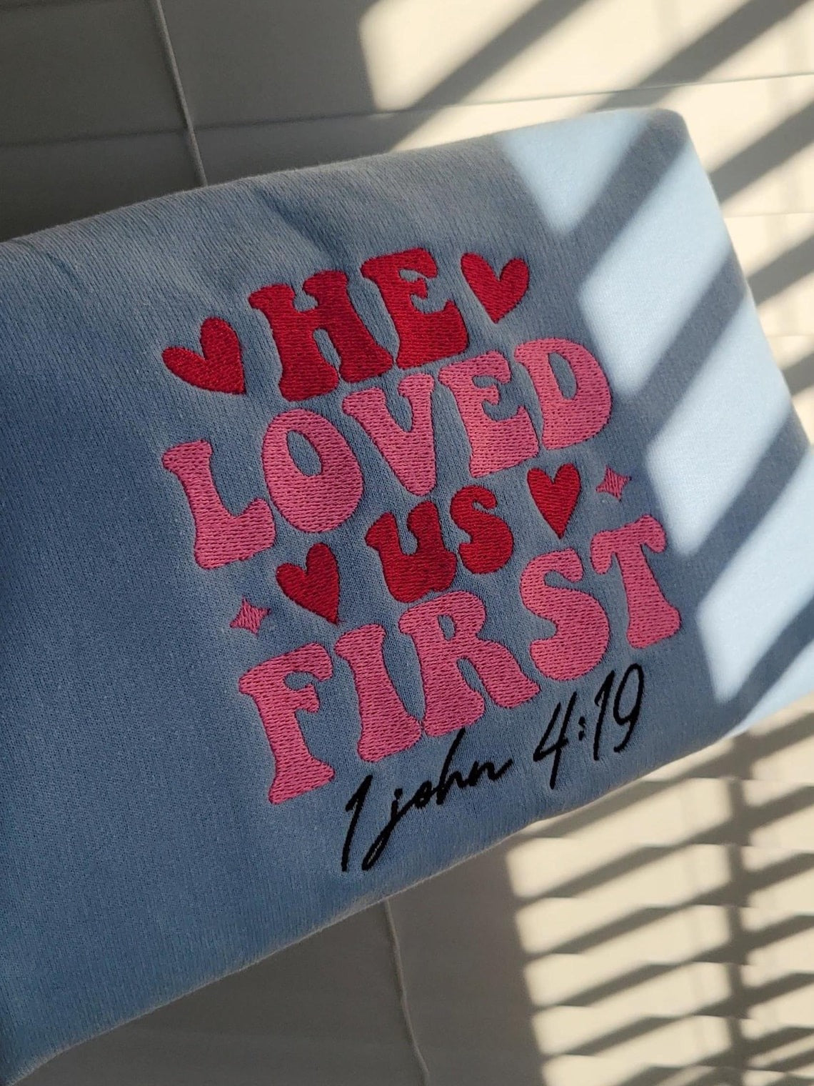 Embroidered He Loved Us First Sweatshirt