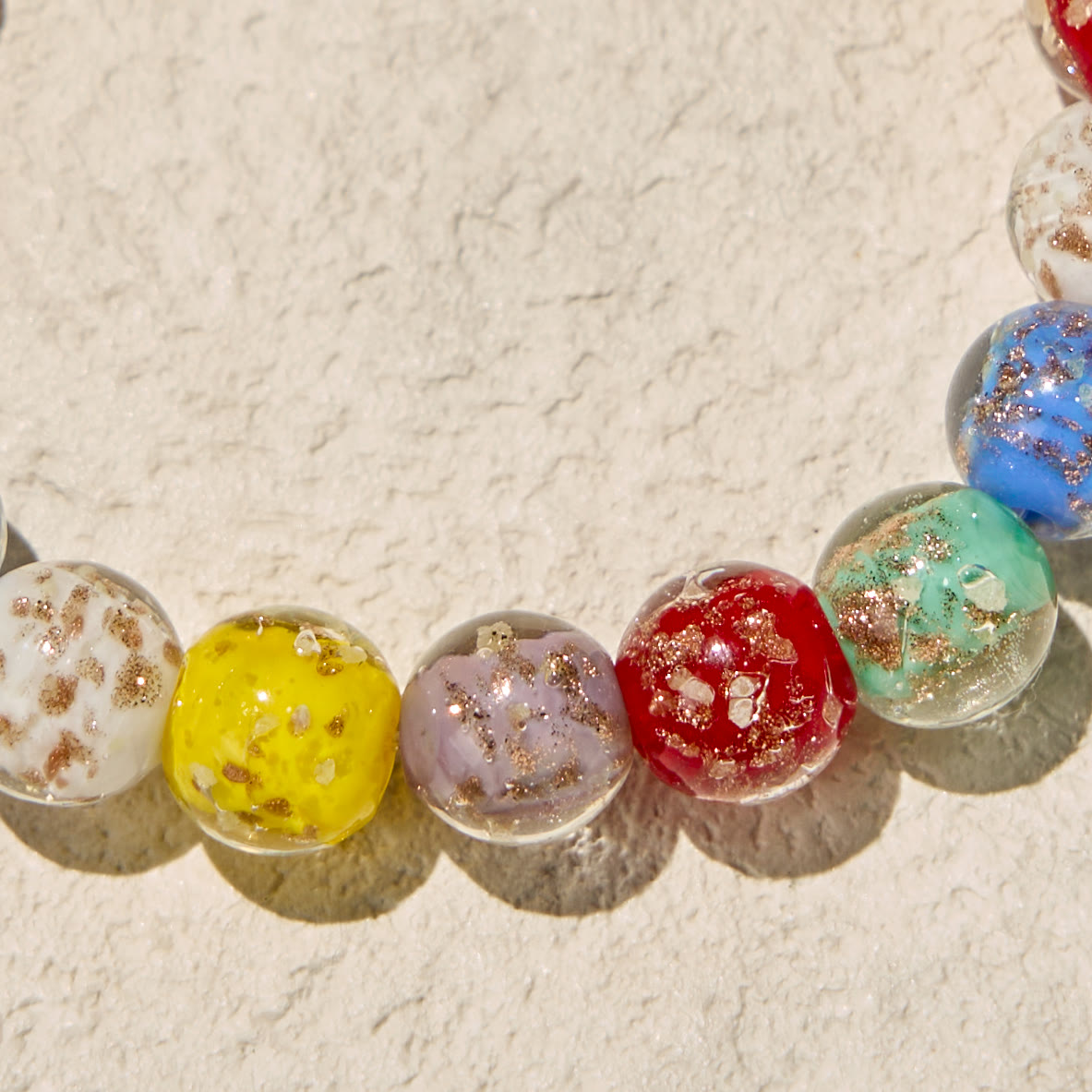 Colorful Glow-in-the-Dark Gold-Flecked Glass Bracelets with Crucifix